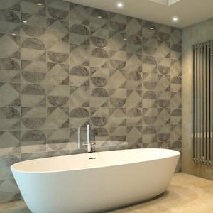May include: A modern bathroom featuring a white oval bathtub. The wall behind the tub is tiled with a geometric pattern in shades of gray and beige. A chrome faucet and a vertical radiator are also visible.