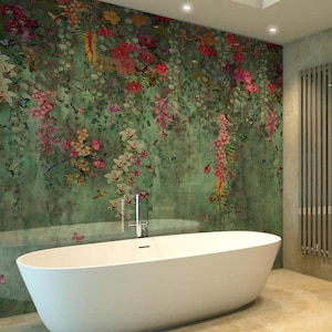 May include: A white oval bathtub is in front of a wall covered in a floral mural. The mural features a green background with pink, red, and white flowers, butterflies, and hummingbirds. A silver faucet is mounted on the wall.