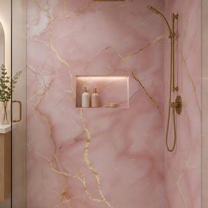 May include: A luxurious shower with pink marble walls and gold veining. The shower features a gold rain shower head, a handheld shower, and a built-in shelf with toiletries. The overall design is elegant and modern, creating a spa-like atmosphere.
