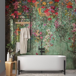 May include: A modern bathroom with a white, oval-shaped bathtub and a floral wallpaper backdrop. A black metal towel rack holds a beige robe. A wooden side table holds toiletries. The wallpaper features colorful flowers and butterflies.