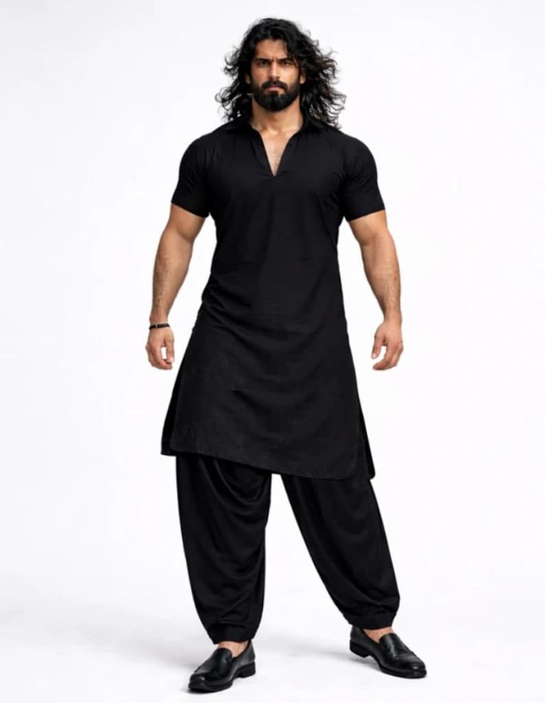 May include: A black kurta and salwar suit. The short-sleeved kurta has a V-neck and a long, flowing design. The salwar trousers are loose and gathered at the ankles. The outfit is paired with black leather shoes.