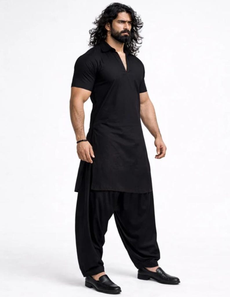May include: A black kurta and salwar suit. The short-sleeved kurta has a collared neckline and a side slit. The salwar trousers are loose-fitting. The outfit is paired with black leather shoes. The background is plain white.