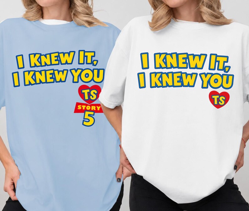 May include: A light blue t-shirt and a white t-shirt, each featuring the yellow text I KNEW IT, I KNEW YOU with a red heart containing the letters TS above the red text STORY 5 in a bold, blocky font style on the front of the garments.