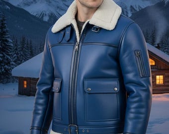 May include: A blue leather jacket with a white shearling collar and cuffs. The jacket features a front zipper, two front pockets, and a buckled belt at the waist. The background shows a snowy mountain landscape.