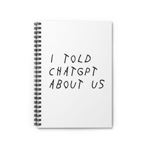 Może przedstawiać: Biały notatnik w spiralę z czarnym tekstem "I TOLD CHATGPT ABOUT US". Notatnik ma srebrną spiralną oprawę.