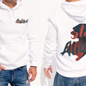 May include: White hoodie with a front pocket and a hood. The front of the hoodie has the word "Aligned" in a stylized font with red and black accents. The back of the hoodie features the words "Stay Aligned" in a similar style.