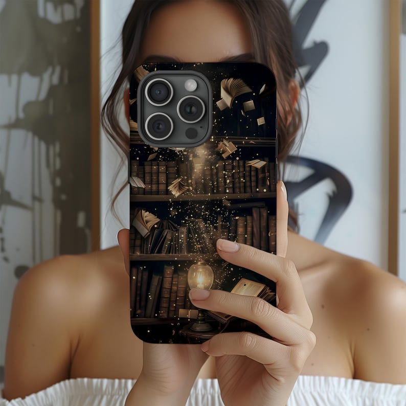 May include: Black phone case featuring a detailed illustration of a library bookshelf with floating books and a glowing light. The design includes stacks of books in various sizes and colors, creating a vintage aesthetic.