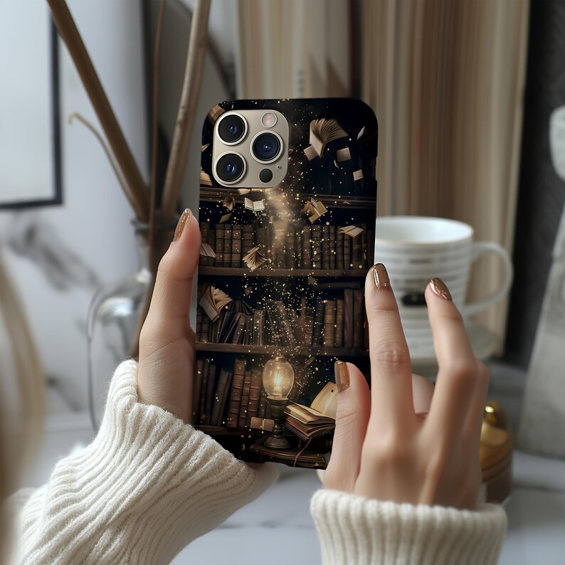 May include: A phone case featuring a detailed illustration of a library bookshelf with floating books and a glowing light. The case has a dark background with a vintage aesthetic, and the design is printed on a sleek, protective cover.
