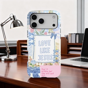 May include: A phone case with a floral and gingham pattern. The case features the text "LOVE LIKE JESUS" in blue, with a pink section at the bottom that reads "God is within her, She will not fail."
