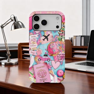 May include: Pink and blue travel-themed phone case featuring a world map design with a pink globe, airplane, and passport. The case includes the words "London", "New York", "Paris", "Amsterdam", "Havana", and "Venice".