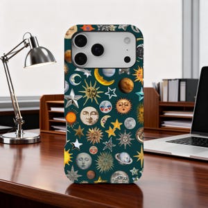 May include: A dark green phone case featuring a celestial pattern of suns, moons, stars, and planets in various colors. The case has a camera cutout and a sleek design, perfect for protecting a smartphone.