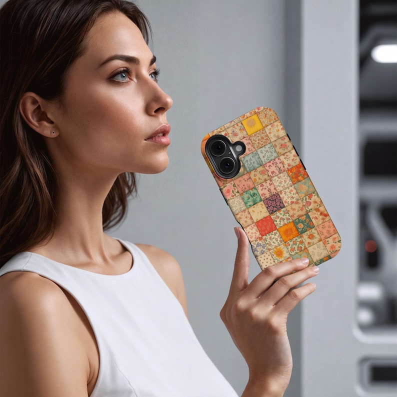 May include: A colorful phone case featuring a patchwork design with squares of various floral patterns in shades of red, orange, yellow, and green. The case has a black border and a camera cutout.
