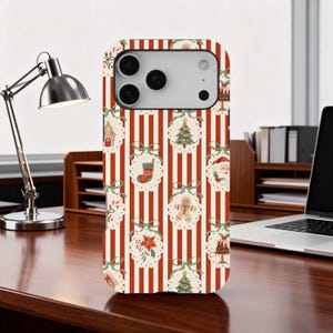 May include: A phone case with a festive Christmas design. The case features a pattern of red and white stripes with repeating holiday ornaments, including gingerbread men, Christmas trees, and Santa Claus. The ornaments are set against a cream-colored background.