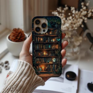 May include: A phone case featuring a detailed illustration of a bookshelf filled with books, candles, and decorative items. The design incorporates a dark, wood-like texture with a fantasy theme, and a touch of greenery.