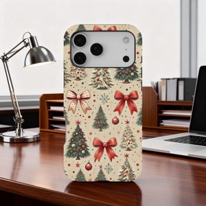 May include: A phone case featuring a festive Christmas pattern. The design includes illustrations of Christmas trees, red bows, snowflakes, and ornaments on a beige background. The case has a camera cutout and button placements.