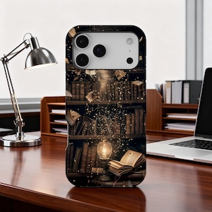 May include: A phone case featuring a detailed illustration of a library with books, a glowing lamp, and floating pages. The design has a vintage aesthetic with warm, inviting colors, suggesting a love for reading and knowledge.