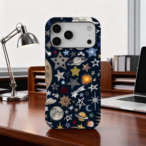 Może przedstawiać: Granatowe etui na telefon z niebiańskim wzorem gwiazd, planet, księżyców i słońc w różnych kolorach. Etui ma błyszczące wykończenie i wycięcie na aparat.