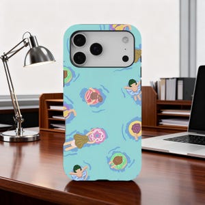 May include: A light blue phone case with a pattern of people floating in inner tubes in a pool. The design includes people with green hair and colourful inner tubes in shades of pink, yellow, and green.