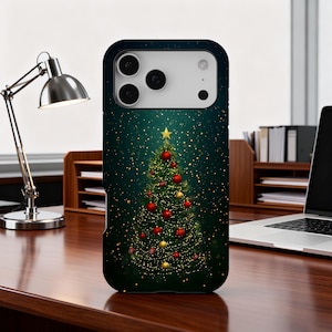May include: A phone case featuring a Christmas tree design. The tree is decorated with red and gold ornaments and topped with a gold star. The background is a dark teal with sparkling white dots.