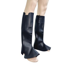 May include: A pair of navy blue riding boots. The boots are knee-high with a smooth, glossy finish. One boot features a buckle detail near the top, while the other has a flared design at the top of the foot.