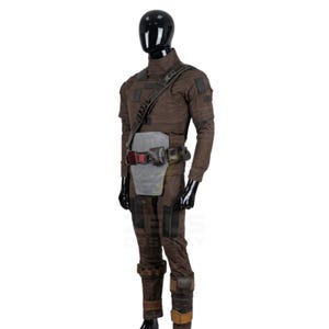 May include: A brown tactical jumpsuit featuring a high collar, long sleeves, and reinforced patches. The outfit includes a dark diagonal shoulder strap, a light gray abdominal plate, and a utility belt with attached pouches and dark hardware.