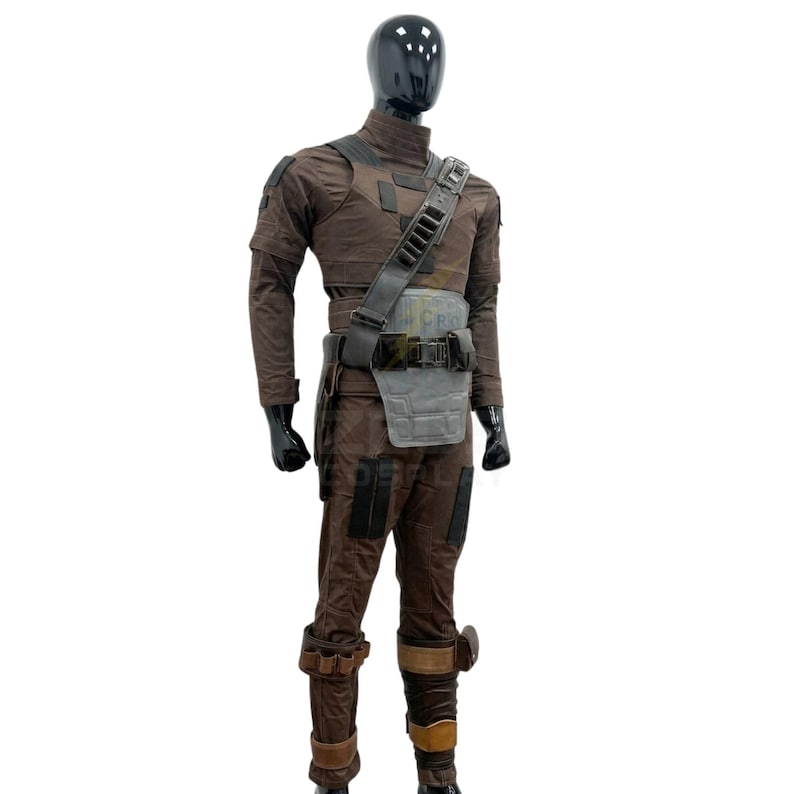 May include: A brown tactical costume set displayed on a black mannequin. The outfit includes a long-sleeved shirt, trousers with dark patches, a utility belt with a grey chest plate, a shoulder strap with ammunition loops, and leg wraps with buckles.