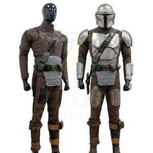 May include: Two full-body costumes displayed on mannequins. The left mannequin wears a brown fabric suit with a dark utility belt and chest plate. The right mannequin wears a matching brown suit with a metallic silver helmet, chest armor, shoulder pauldrons, and gauntlets.