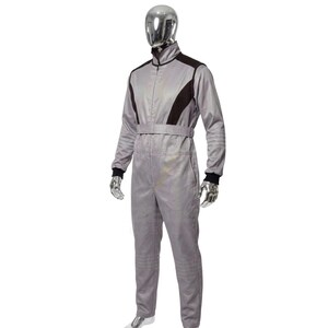 May include: A gray racing suit with black accents on the shoulders and upper chest. The suit has a zip-up front, a belt at the waist, and black cuffs at the wrists and ankles. The suit is displayed on a mannequin.