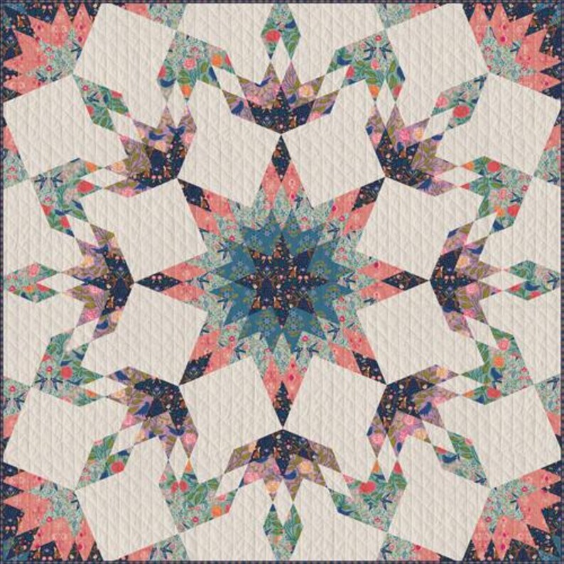 May include: A quilted textile featuring a central starburst design in shades of teal, pink, and navy blue. The star is surrounded by geometric shapes with floral patterns and white quilted sections. The quilt has a navy blue border.