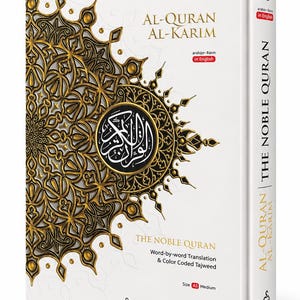 May include: A white hardback book titled Al-Quran Al-Karim The Noble Quran with word-by-word translation and colour coded Tajweed. The cover features a large, intricate gold and black mandala-style pattern and the Karya Bestari logo at the bottom.