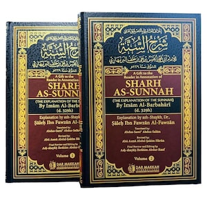 May include: Two hardcover books titled Sharh As-Sunnah, Volume 1 and Volume 2, by Imam Al-Barbahari. The covers are dark blue with gold ornate borders and text in both Arabic and English. The central panels are maroon with white and gold lettering.