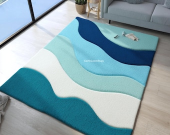May include: A rectangular area rug with a wave-like design in shades of blue and white. The rug features a textured surface and the text "EarthLoomRugs" is visible. The rug is placed on a light-colored wooden floor.
