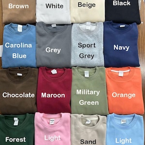 May include: A set of three ceramic mugs with a speckled, matte finish. The mugs are in shades of cream, light gray, and dark gray. Each mug has a simple, minimalist design, perfect for coffee or tea.