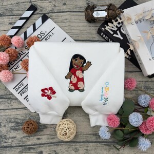 May include: A white ceramic mug with a black handle and the text "But First, Coffee" in a bold, black font. The mug is set against a blurred background, suggesting a cozy setting.