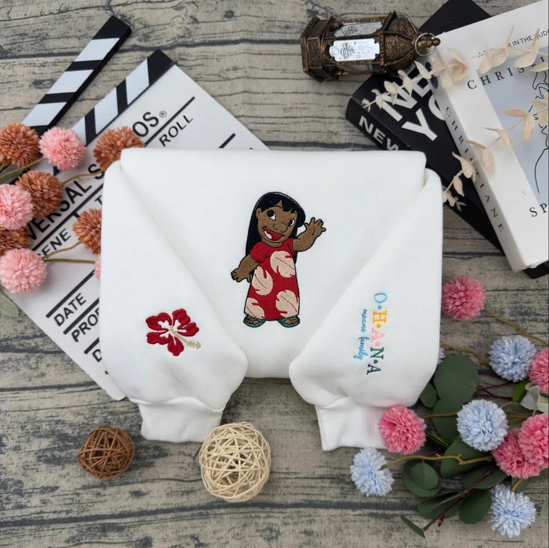 May include: A white ceramic mug with a black handle and the text "But First, Coffee" in a bold, black font. The mug is set against a blurred background, suggesting a cozy setting.