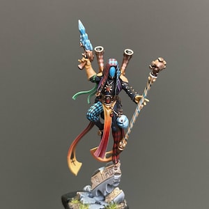 May include: A set of three ceramic nesting bowls in shades of blue, green, and white. The bowls feature a speckled design and varying sizes, perfect for food preparation or serving.