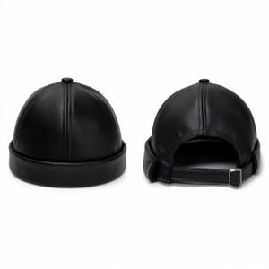 May include: A black faux leather docker cap featuring a rounded crown with stitched paneling and a rolled brim. The back view displays an adjustable strap with a silver-toned metal buckle, allowing for a customizable fit for this brimless headwear.