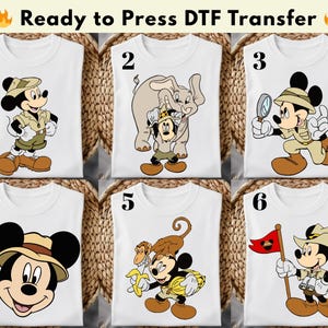 May include: White DTF transfer shirts with Mickey Mouse in safari attire. Each shirt displays a unique design, such as Mickey with an elephant, a magnifying glass, and a flag. The text "Ready to Press DTF Transfer" is at the top.