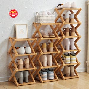 May include: Wooden shoe racks with multiple shelves, arranged in a zig-zag pattern. The racks are filled with various shoes, including heels, boots, and flats. A small framed picture and a basket are also visible.