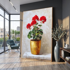 May include: A large framed painting of a potted geranium plant with vibrant red flowers and green leaves. The plant is in a gold-colored pot, set against a neutral background. The painting is displayed in a modern interior setting.