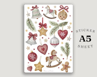 Puede incluir: Hoja de pegatinas A5 con ilustraciones en acuarela de adornos navideños. Incluye campanas, caballos balancín, estrellas y decoraciones en forma de corazón en rojo, blanco y dorado. El texto "Sticker A5 Sheet" está impreso a la derecha.