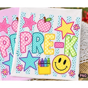 May include: A white fabric square featuring the text PRE-K in colorful checkered letters, surrounded by a pink checkered apple, a yellow star, a yellow smiley face, small flowers, and a yellow pocket containing four colorful crayons.