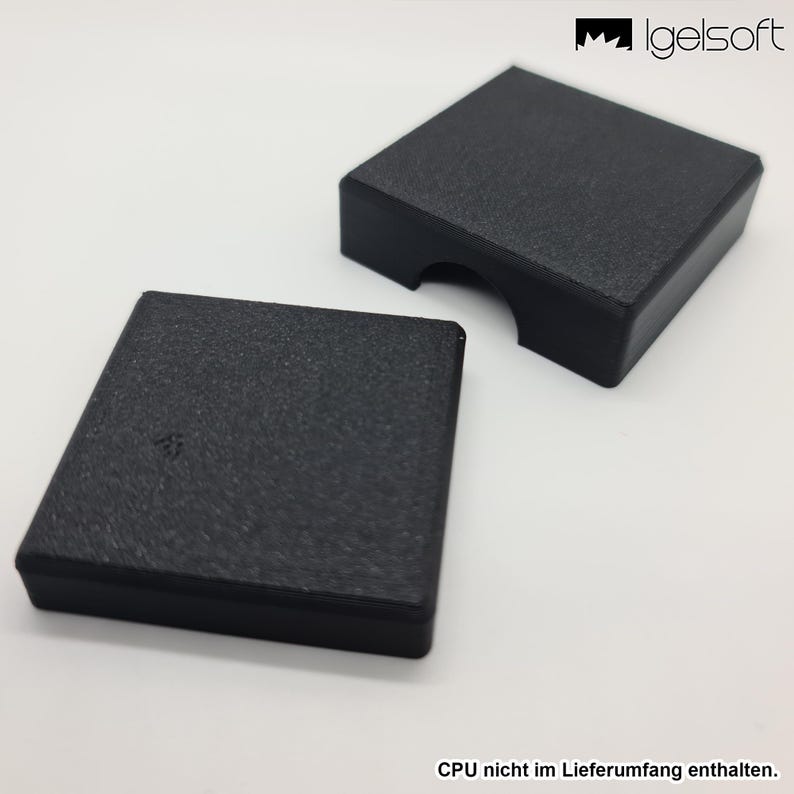 May include: Two black, textured, square-shaped cases. One case has a curved cutout on one side. The cases are on a white surface. The text "CPU nicht im Lieferumfang enthalten" is at the bottom.