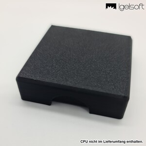 May include: A black, rectangular box with a textured surface. The box has a slot cut out on one side. The image also includes the text "CPU nicht im Lieferumfang enthalten."