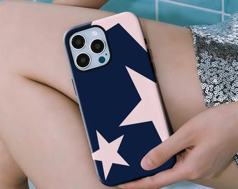 May include: A navy blue phone case with a pink star pattern. The case has a glossy finish and is designed for a smartphone with multiple camera lenses. The stars are of varying sizes and are arranged on the back of the case.