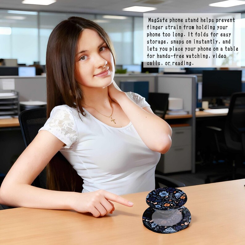 May include: A black and blue floral patterned MagSafe phone stand, open and closed, on a wooden desk. The stand helps prevent finger strain and allows for hands-free phone use. Text on the image reads: MagSafe phone stand helps prevent finger strain...