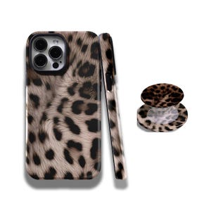 May include: A phone case and phone grip featuring a leopard print design in shades of brown, black, and tan. The phone case is shown from multiple angles, showcasing the design on the back and sides. The phone grip is round and matches the case.