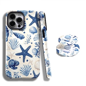 May include: A phone case and matching phone grip with a blue and white seashell and starfish design. The pattern features various seashells, starfish, and aquatic plants on a cream background.