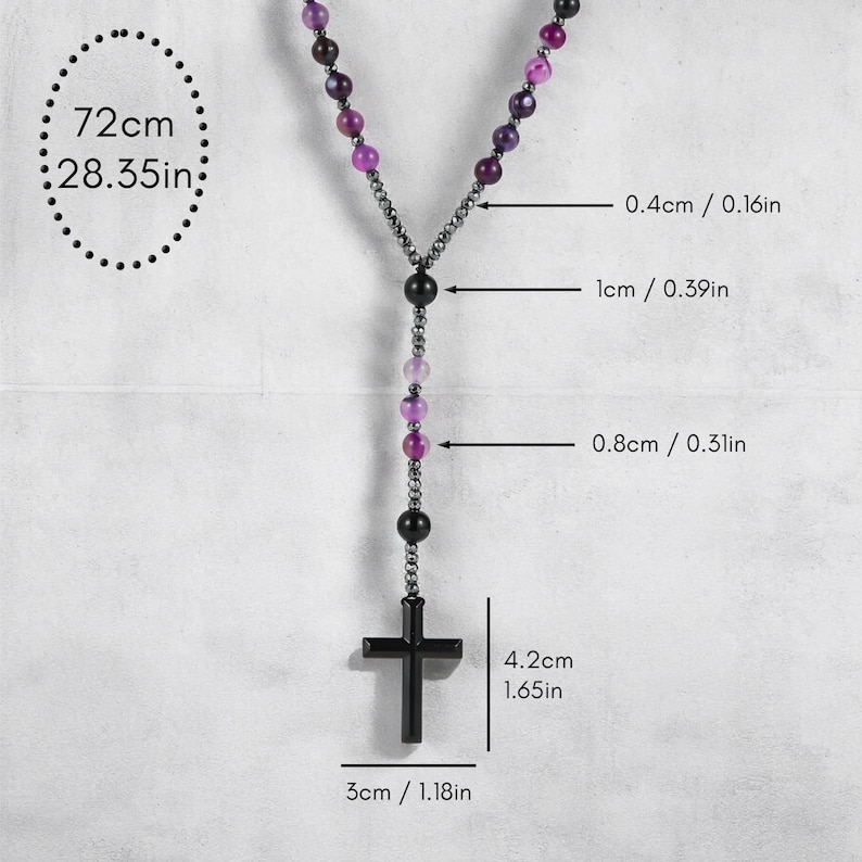 May include: A rosary necklace with purple and black beads and a black cross pendant. The necklace is 72cm (28.35in) long, with the cross measuring 4.2cm (1.65in) high and 3cm (1.18in) wide. The beads are 0.4cm (0.16in), 1cm (0.39in), and 0.8cm (0.31in) in diameter.