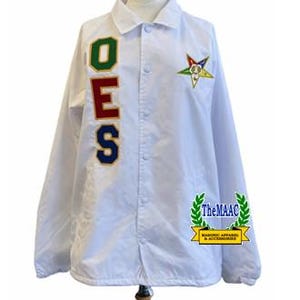 May include: A white coach jacket featuring a vertical OES applique in green, red, and blue on the right chest. A five-pointed star emblem is on the left chest. The jacket has a collar, snap-button closure, and a logo with the text TheMAAC.